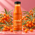Qosha Sea Buckthorn Juice 300 ml bottle surrounded by fresh sea buckthorn berries